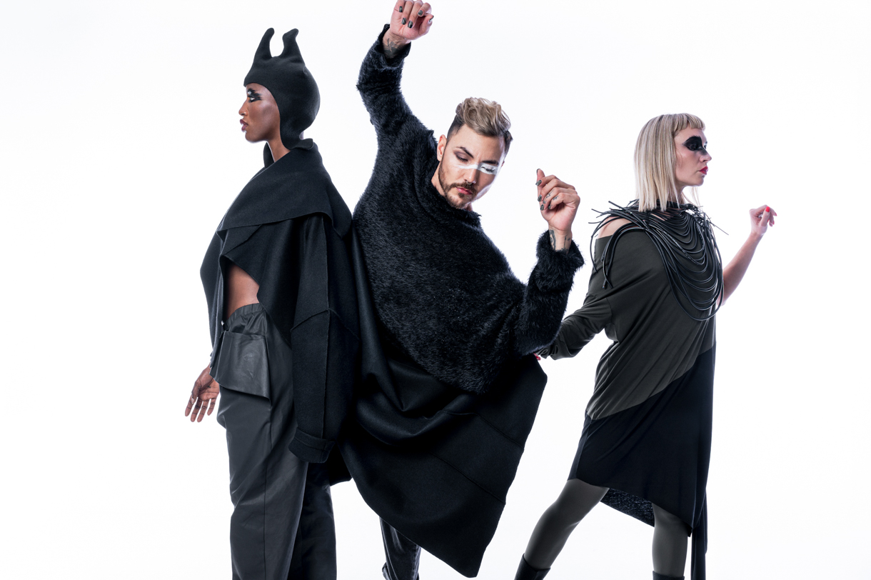 Three models in black and green pieces from the Neu collection